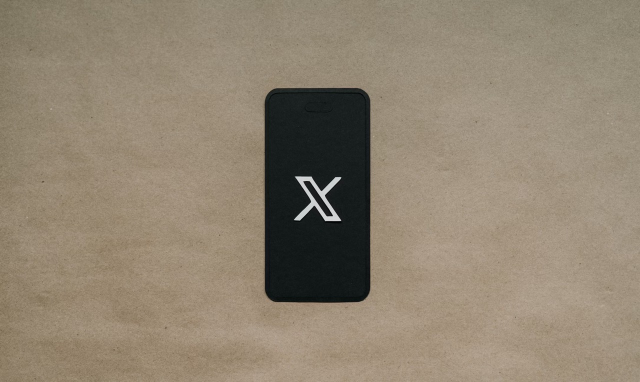 How to Switch Your X (Twitter) Account to Private or A black phone showing the X logo
