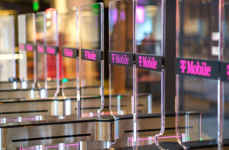 T-Mobile-branded clear barrier gates that employees must pass through with a badge.